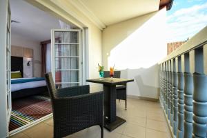 a balcony with a table and chairs and a bed at Stay inn Hotel Gdańsk in Gdańsk