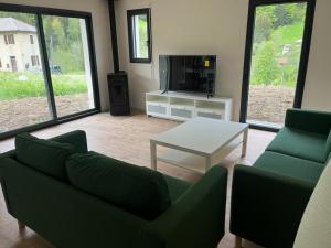 a living room with a couch and a coffee table at Luxurious new villa in the Alpes with sauna and jacuzzi in Bellevaux