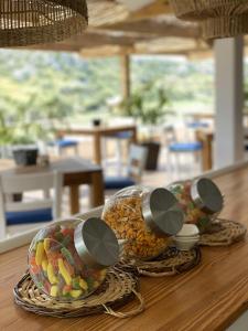 two containers of fruit sitting on a table at Osprey Menorca Hotel in Cala en Porter