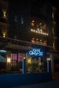 a building with a sign for a restaurant at night at GS RESIDENCY in Guwahati