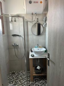a small bathroom with a sink and a shower at Vassilis Retreat in Asos