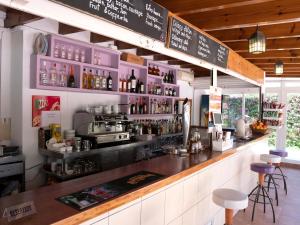 a bar in a restaurant with a counter with drinks at Apartamentos Arlanza - Only Adults in Playa d'en Bossa