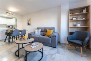 a living room with a couch and two tables at CT 245 - Faro's Arroyo de la Miel Apartment - Cuddly Nest for 2 in Arroyo de la Miel