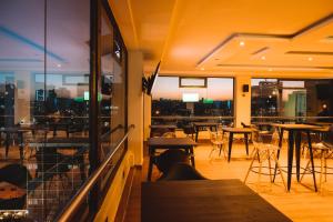 a restaurant with tables and chairs and a view of the city at Kije Place Hotel in Nairobi