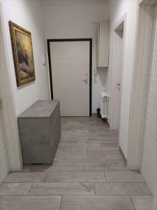 a hallway with a door and a tile floor at AFFITTACAMERE S.ORSOLA - MALPIGHI in Bologna +1 photo