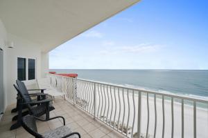 a balcony with chairs and a view of the ocean at Coral Reef Resort by Panhandle Getaways in Panama City Beach