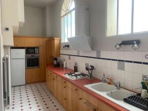 a kitchen with a sink and a stove top oven at Maison classée 3 étoiles à Vouvray Loire Valley in Vouvray