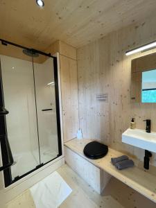 a bathroom with a shower and a toilet and a sink at Slow Cabins Kinvara in Kinvara