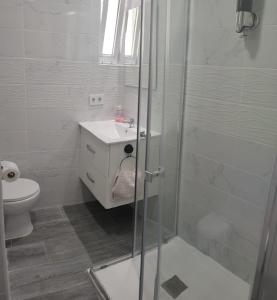 a bathroom with a shower and a sink and a toilet at Altura in Valencia