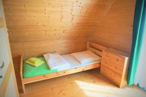 a small wooden sauna with a bed in it at Zielone Domki in Pobierowo