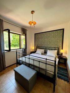 a bedroom with a bed and a large window at Apartmani Zora in Cres