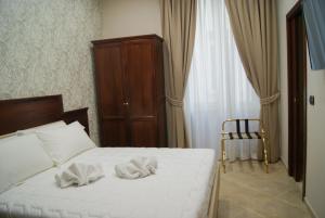 a bedroom with a bed with two towels on it at Esposizione Boutique in Rome
