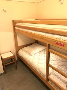two bunk beds in a small room with a stool at Cap Estérel by Actisource in Agay - Saint Raphael
