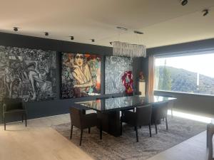 a dining room with a glass table and chairs at Luxurious studio suite near Monaco with sea view in Éze