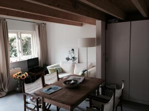 a living room with a table and a couch at Almost At The Beach in Wijk aan Zee