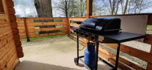 a grill with a television on top of it at The Willow Cabin - Wild Escapes Wrenbury off grid glamping - ages 12 and over in Wrenbury
