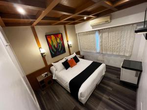Ένα ή περισσότερα κρεβάτια σε δωμάτιο στο Sarmiento Palace Hotel