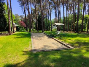 a park with a bench and a gazebo in the grass at La Maison de Lise in Ville-Pommeroeul