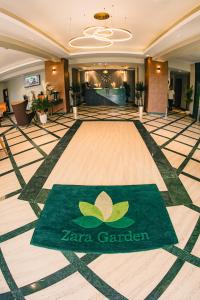a lobby with a zero garden sign on the floor at Zara Garden Hotel and Apartments in Kampala