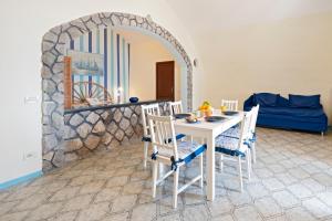 a dining room with a table and chairs and a mirror at Marina del Cantone Chalet in Nerano