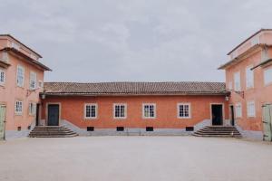 a large orange building with steps in a courtyard at Casa de Sezim in Guimarães