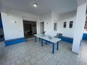 a blue table in the middle of a room at Mediterranean Dolphin Guest House in Paránimfoi