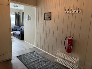 a living room with a fire extinguisher on the wall at The Painter's house with view and balcony in Siglufjörður