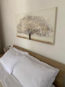 un dipinto di un albero sul muro sopra un letto di Su Hantaru Vetzu a Mamoiada