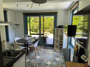 a kitchen with a table and a dining room at La Maison de Lise in Ville-Pommeroeul