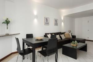 a living room with a black table and a couch at Algamar Apartment - Vilamoura Center in Vilamoura