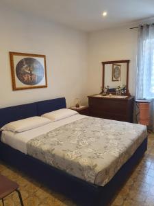 a bedroom with a bed and a table and a mirror at Casa di Marisa in Trevignano Romano