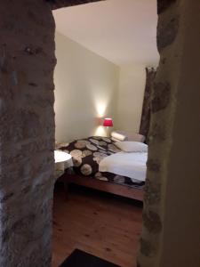 a bedroom with a bed and a stone wall at Appart rénové - 10 minutes à pied de la cathédrale in Quimper