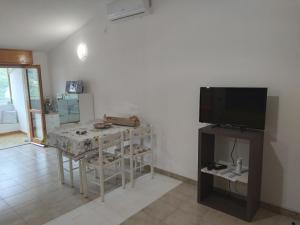 a living room with a table and a television at Praia Sea Home, Casa Vacanze in Praia a Mare
