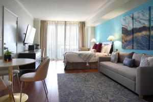 a living room with a couch and a bed in a room at Glamorous Bay View Studio In The Heart Of Grove in Miami