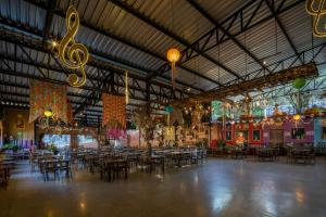 a large room with tables and chairs and lights at Hotel Fazenda Vilarejo All Inclusive in Conservatória