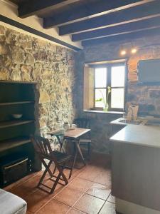 a kitchen with a table and chairs in a room at La Fontanina de Mario in Villaviciosa +37 photos