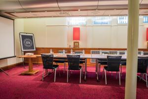 a conference room with a large table and chairs at The Townhouse Manchester in Manchester