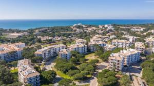 an aerial view of a city with houses and the ocean at Pine Sun Park Т1 apartment Falesia beach in Olhos de Água