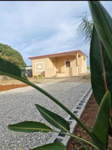 a small house on the side of a gravel road at Curmo beach & relax in Le Castella