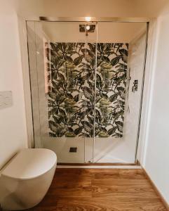 a bathroom with a toilet and a glass shower at Appartamento il Rosmarino in Portoferraio