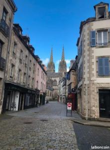a cobblestone street in an old city with buildings at Location 2 pers centre historique de quimper in Quimper