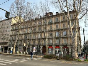 a man crossing a street in front of a building at Typical one bedroom apartment in Turin center in Turin