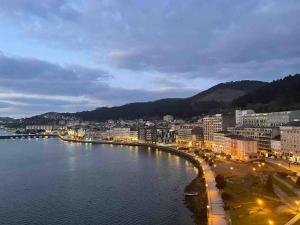 a view of a city with a body of water at Piso vacacional con terraza panorámica a la ría. in Viveiro