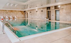a large swimming pool in a large room with a pool at Blue Baltic & SPA in Dziwnów