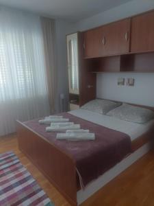 a bedroom with a large bed with towels on it at Apartment M&M in Split