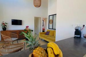 a living room with a table with bananas and pineapple at Villa Sud Sauvage in Saint-Philippe