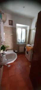a bathroom with a white sink and a toilet at Casa di Marisa in Trevignano Romano
