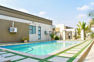 a swimming pool in front of a house at Forefront Self-Catering Apartments in Kitwe