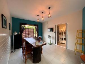 a dining room with a table and chairs at Naisang Hostel in Chumphon