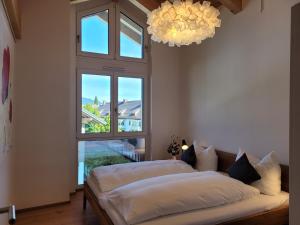 two beds in a room with a large window at Alpenglück-Garmisch in Garmisch-Partenkirchen